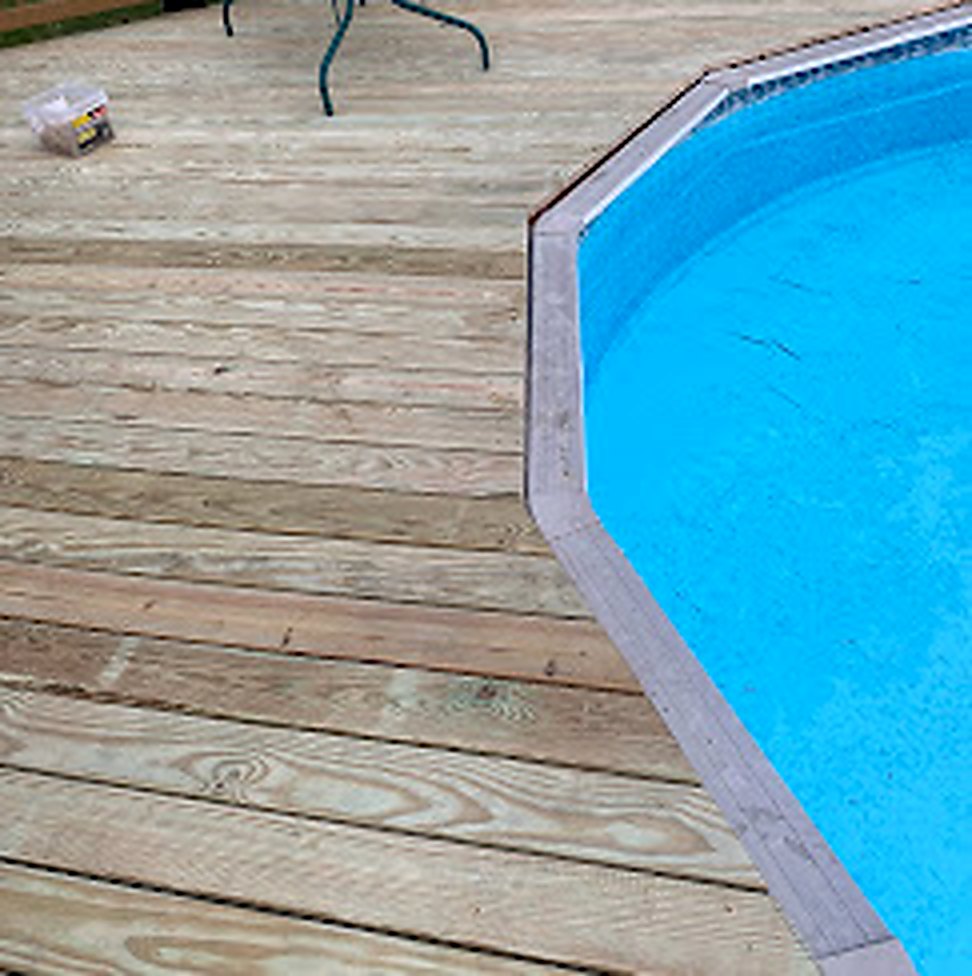 Completed wood deck around above-ground pool in Central NJ